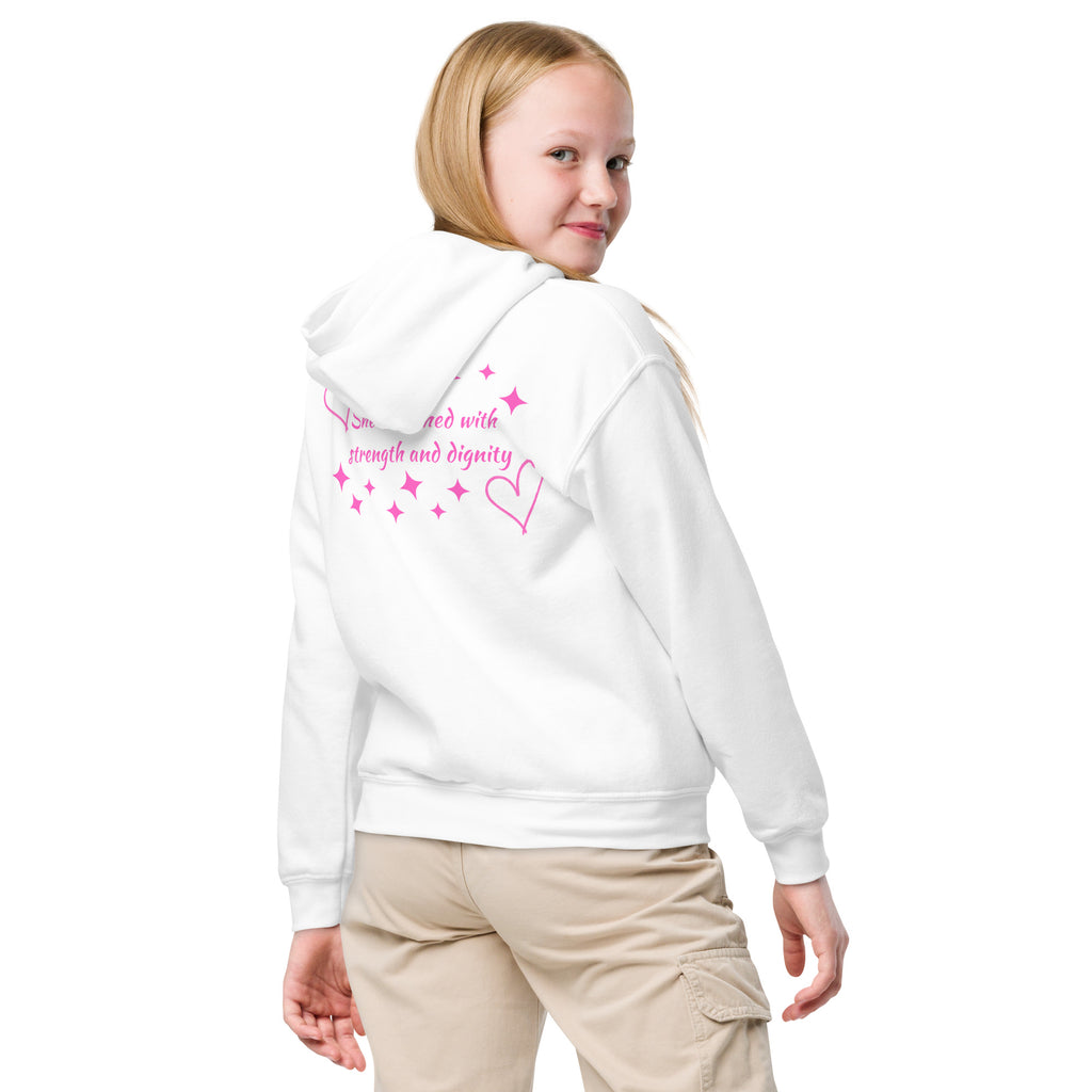 Girl wearing a white girls Christian hoodie showing the back design with dark pink hearts and stars and the Scripture text reading She is clothed with strength and dignity from Proverbs 31:25
