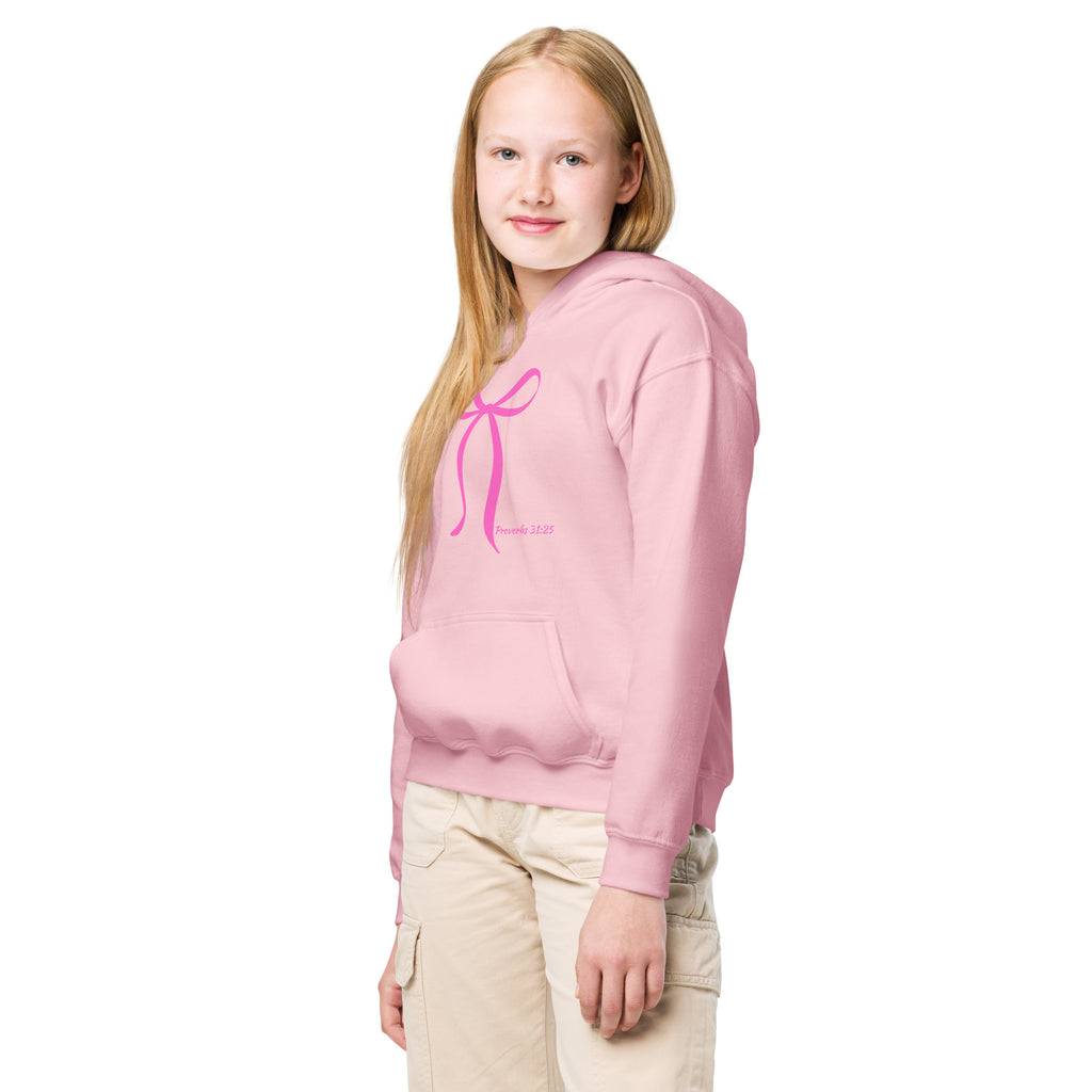 Girl wearing light pink Christian hoodie showing Proverbs 31:25 bow design on front