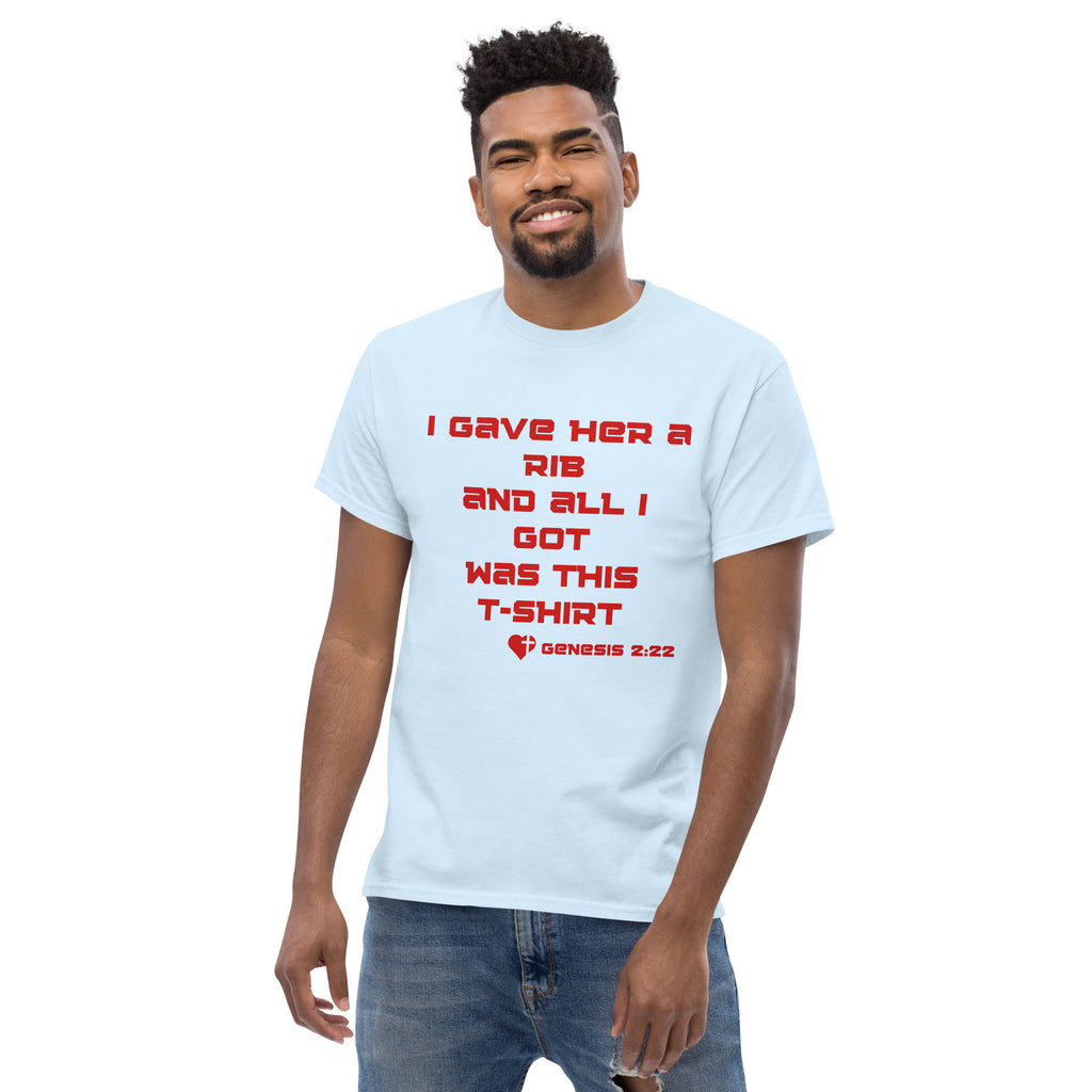 Male model wearing a light blue men’s Christian t-shirt showing the front design with the text “I gave her a rib and all I got was this t-shirt” and “Genesis 2:22” in red font with a heart and cross graphic.