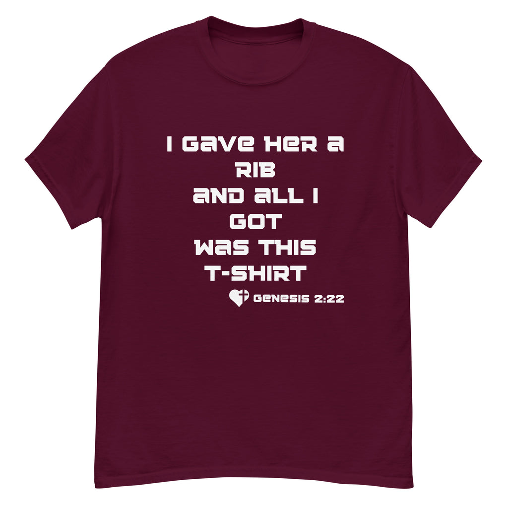 Flat lay front view of men’s Christian t-shirt in maroon featuring the text “I gave her a rib and all I got was this t-shirt” with “Genesis 2:22” in white font alongside a heart and cross graphic.