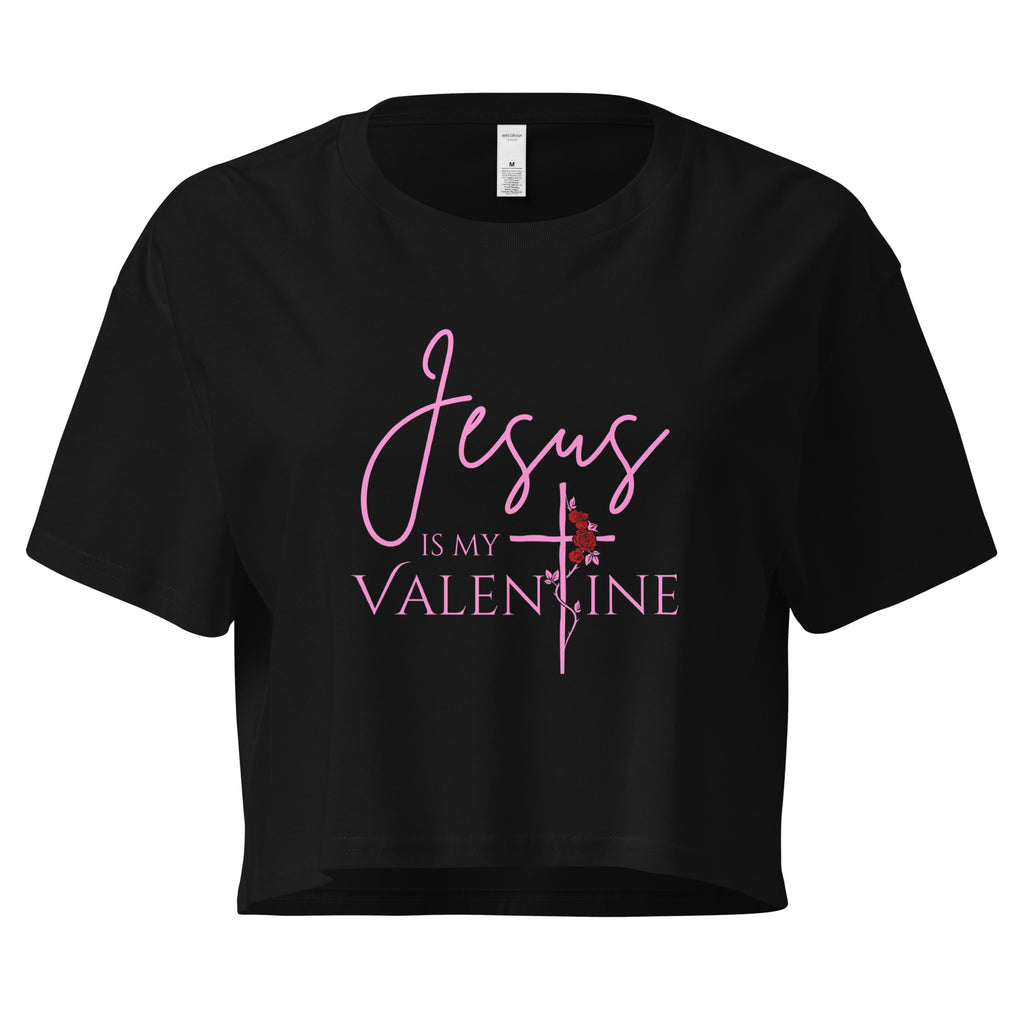 Flat lay of women’s Christian crop top in black featuring the text Jesus Is My Valentine with the T designed as a cross wrapped in a rose