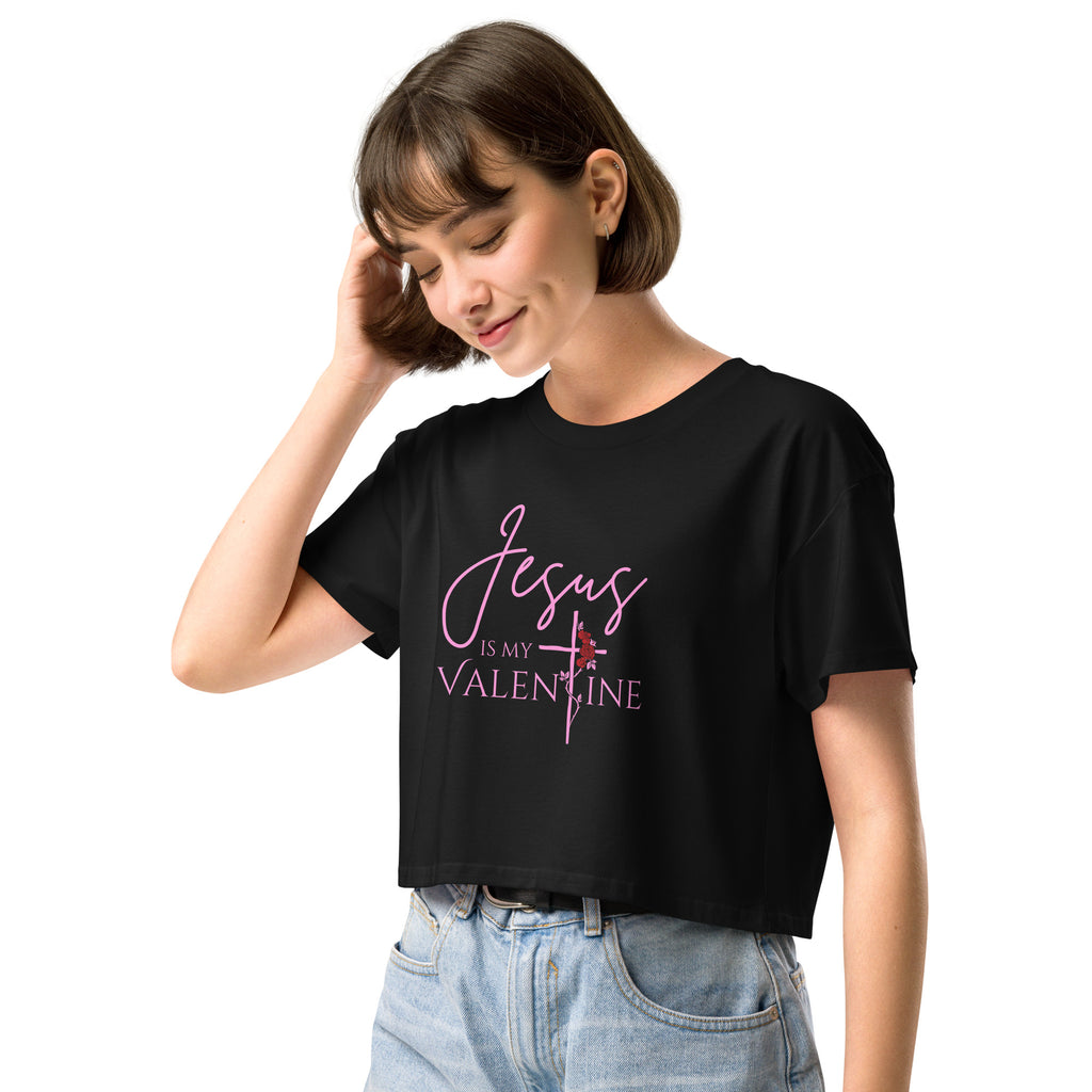 Close-up of a woman wearing the black Jesus Is My Valentine Christian crop top showing the cross and rose detail