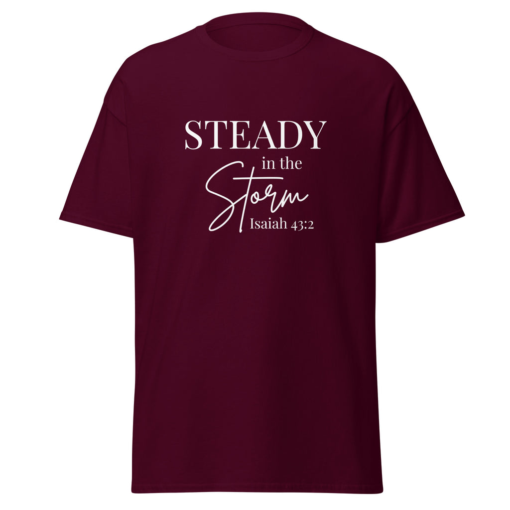 Maroon women’s Christian t-shirt lay flat front view featuring the text “STEADY in the Storm Isaiah 43:2” with Storm in a handwritten script style and the rest in block lettering