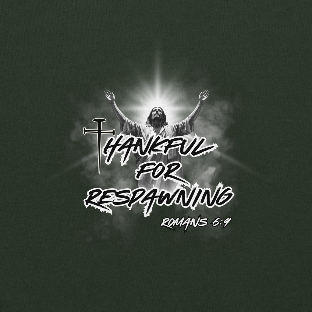 Close-up of the forest green men’s Christian hoodie emphasizing the full design text “Thankful for Respawning” and “Romans 6:9,” the “t” formed by three nails, and Jesus looking to Heaven with His arms raised with radiant light and clouds behind Him.