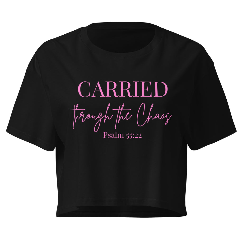 Black women’s crop t-shirt lay flat front featuring the left chest text “CARRIED through the Chaos Psalm 55:22.” “Through the Chaos” appears in a handwritten font.